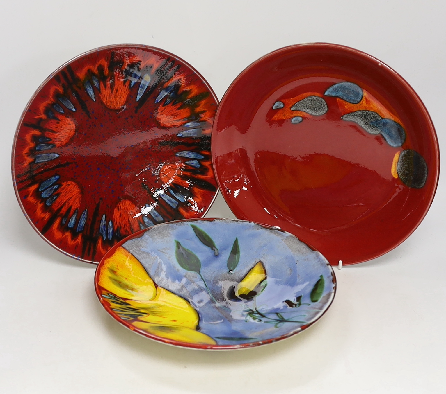 Three Poole Pottery ‘Delphis’ wall plates, 25cm